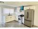 Modern kitchen with white cabinets, stainless steel appliances, and marble countertops at 9508 Conried Dr, Indianapolis, IN 46235