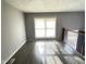 Bright living room with gray walls, wood-look floors, and a view to the backyard at 9508 Conried Dr, Indianapolis, IN 46235