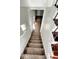 Stairs leading to the lower level with carpet runners at 9508 Conried Dr, Indianapolis, IN 46235