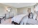 Modern bedroom with large bed, carpet, accent furniture, and a round mirror at 1445 Bellows Ave, Franklin, IN 46131