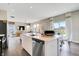 Open concept kitchen island boasts a stainless dishwasher and sink overlooking the living and dining area at 1445 Bellows Ave, Franklin, IN 46131