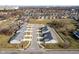 Aerial view showing a new development of townhouses, featuring a unique curved street design at 1623 Capra Ct, Beech Grove, IN 46107