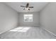 Spacious bedroom with ceiling fan and neutral gray walls at 1623 Capra Ct, Beech Grove, IN 46107