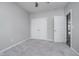 Well-lit bedroom featuring double doors and plush carpeting at 1623 Capra Ct, Beech Grove, IN 46107