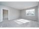 Spacious carpeted bedroom with large window and door at 1623 Capra Ct, Beech Grove, IN 46107
