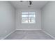 Spacious bedroom with carpet flooring and a window offering natural light at 1623 Capra Ct, Beech Grove, IN 46107