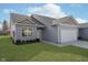 Gray siding ranch home with attached garage and landscaping at 1623 Capra Ct, Beech Grove, IN 46107