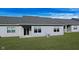 Back of house with gray siding, patio, and grassy area at 1623 Capra Ct, Beech Grove, IN 46107