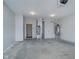 Unfinished garage with concrete flooring, water heater, and HVAC unit at 1623 Capra Ct, Beech Grove, IN 46107