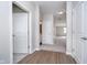 Hardwood floor hallway with doors to bedrooms and bath at 1623 Capra Ct, Beech Grove, IN 46107