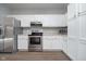 Modern kitchen with stainless steel appliances and white cabinets at 1623 Capra Ct, Beech Grove, IN 46107