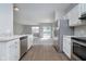 Kitchen with stainless steel appliances and view into living room at 1623 Capra Ct, Beech Grove, IN 46107