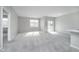 Spacious living room with carpeting and sliding glass door at 1623 Capra Ct, Beech Grove, IN 46107