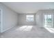 Bright main bedroom with carpeting and sliding glass door at 1623 Capra Ct, Beech Grove, IN 46107