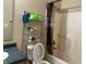 Clean bathroom with bathtub, toilet and shelving unit at 1810 Farm Meadow Dr, Greenwood, IN 46143