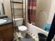 Bathroom with bathtub, toilet, and shelving unit at 1810 Farm Meadow Dr, Greenwood, IN 46143