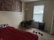 Bedroom with a bed, window, and small table at 1810 Farm Meadow Dr, Greenwood, IN 46143