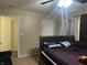 Bedroom with a bed, ceiling fan and access to another room at 1810 Farm Meadow Dr, Greenwood, IN 46143