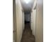 Long hallway with carpeted floor and doors to bedrooms at 1810 Farm Meadow Dr, Greenwood, IN 46143