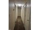 Long hallway with carpeted flooring and multiple doors leading to rooms at 1810 Farm Meadow Dr, Greenwood, IN 46143