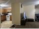 Kitchen with wood cabinets, stove, and view to living room at 1810 Farm Meadow Dr, Greenwood, IN 46143