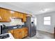 Kitchen with wood cabinets, stainless steel appliances, and a double sink at 1837 E Legrande Ave, Indianapolis, IN 46203