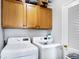 Laundry room with LG washer and dryer, and wood cabinets at 1837 E Legrande Ave, Indianapolis, IN 46203