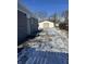Backyard with detached garage and partially snow-covered driveway at , Indianapolis, IN 46203