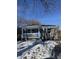 Gray brick ranch home with white porch and blue door, freshly landscaped yard at , Indianapolis, IN 46203