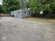 Rear view of house with long driveway, detached garage, and side yard at 2414 Walker Ave, Indianapolis, IN 46203