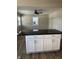 White kitchen island with granite countertop, offering extra workspace and storage at , Indianapolis, IN 46203