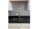 Modern double sink with gray tile backsplash and granite countertop at , Indianapolis, IN 46203