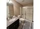 Well lit bathroom featuring modern finishes, a black granite countertop and a glass enclosed shower at 2504 Fawn Bluff Ct, Zionsville, IN 46077