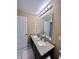 Bathroom with a large vanity with a granite countertop and double sinks at 2504 Fawn Bluff Ct, Zionsville, IN 46077