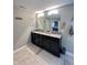 Bathroom with a large mirror above a double sink vanity with granite countertops at 2504 Fawn Bluff Ct, Zionsville, IN 46077