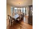 Spacious dining room with a large dining table, upholstered chairs, and hardwood flooring, with a view to the foyer at 2504 Fawn Bluff Ct, Zionsville, IN 46077