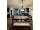 Open-concept dining area with dark wooden table, connecting to modern kitchen at 2504 Fawn Bluff Ct, Zionsville, IN 46077