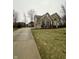 Beautiful two-story home showcasing a brick and stone exterior, complemented by a long driveway and lush lawn at 2504 Fawn Bluff Ct, Zionsville, IN 46077