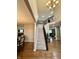 View of the foyer showcasing the staircase, hardwood floors, and high ceilings at 2504 Fawn Bluff Ct, Zionsville, IN 46077