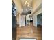 Inviting foyer with hardwood floors, a staircase, chandelier, and views into the living spaces at 2504 Fawn Bluff Ct, Zionsville, IN 46077