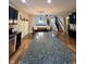 Open concept kitchen featuring black cabinets, granite countertops and views into the dining and living areas at 2504 Fawn Bluff Ct, Zionsville, IN 46077