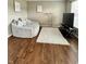 Cozy living room featuring hardwood floors, a plush sofa, and a modern entertainment center at 2504 Fawn Bluff Ct, Zionsville, IN 46077