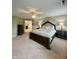 Cozy main bedroom featuring a large bed, side tables, and a doorway leading to the attached bathroom at 2504 Fawn Bluff Ct, Zionsville, IN 46077