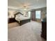 Spacious main bedroom with a large bed, side tables, and a ceiling fan for comfortable living at 2504 Fawn Bluff Ct, Zionsville, IN 46077