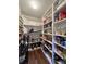 Walk-in pantry with floor-to-ceiling shelving, providing ample storage space for food and household items at 2504 Fawn Bluff Ct, Zionsville, IN 46077