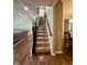Carpeted staircase with dark wood railing leading to the upper level, connecting the living spaces at 2504 Fawn Bluff Ct, Zionsville, IN 46077