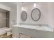 Bathroom with double vanity, updated mirrors, and a tub at 2832 S Oakland Ave, Indianapolis, IN 46203