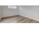 Simple bedroom with a window and light wood laminate floors at 2832 S Oakland Ave, Indianapolis, IN 46203