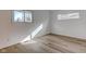 Well-lit bedroom with two windows and light wood laminate flooring at 2832 S Oakland Ave, Indianapolis, IN 46203