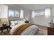 Comfortable bedroom with a bed flanked by mid-century modern nightstands and light filtering windows at 2832 S Oakland Ave, Indianapolis, IN 46203
